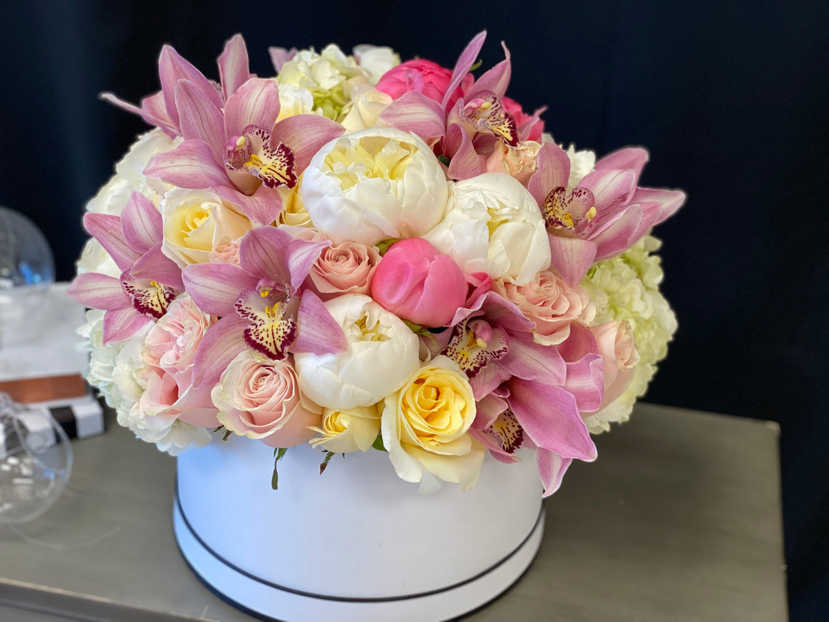 Pink roses and orchid arrangement by Luxury Flowers Miami