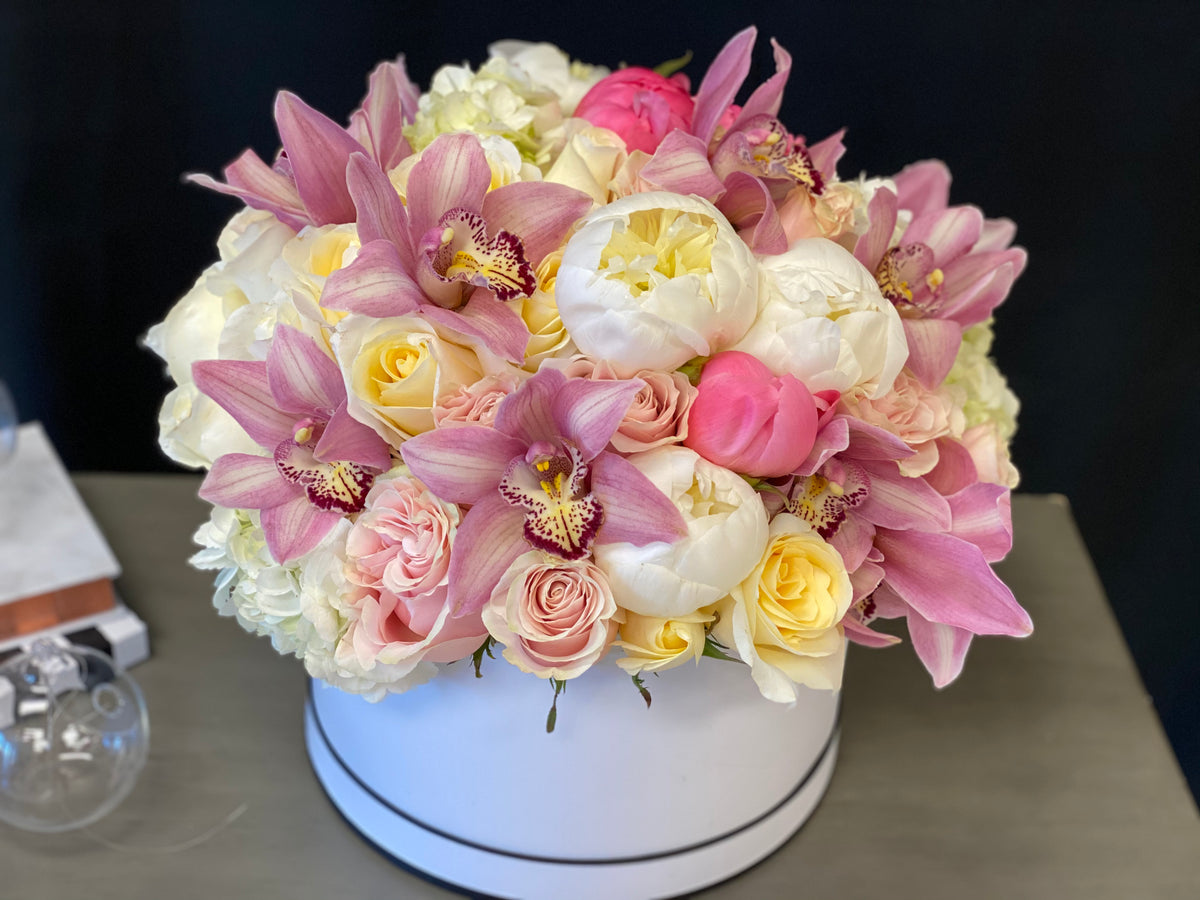 Pink roses peonies and cymbidium orchid flower arrangement