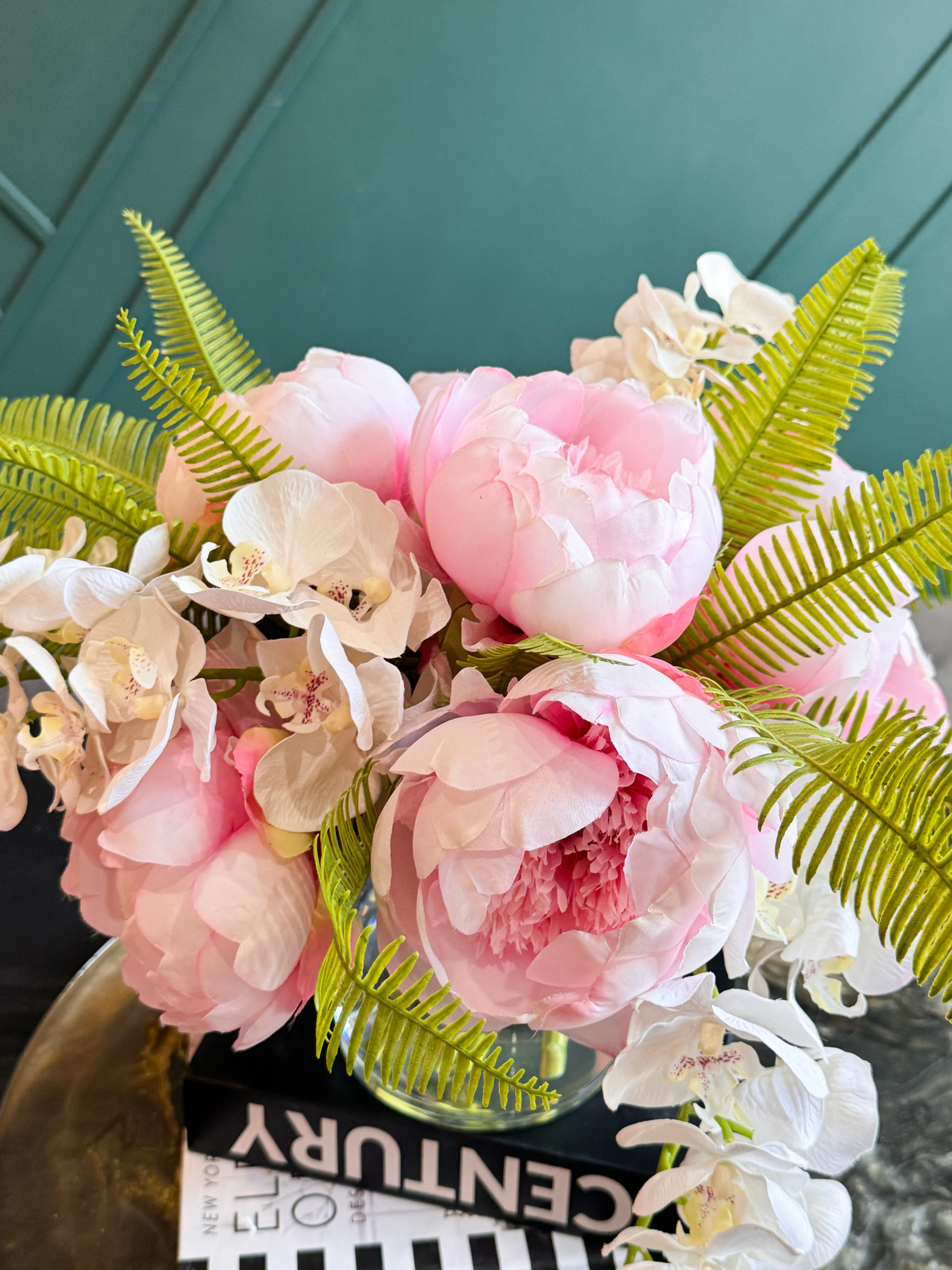 Premium artificial flower arrangement with realistic peonies, orchids, and fresh green foliage.