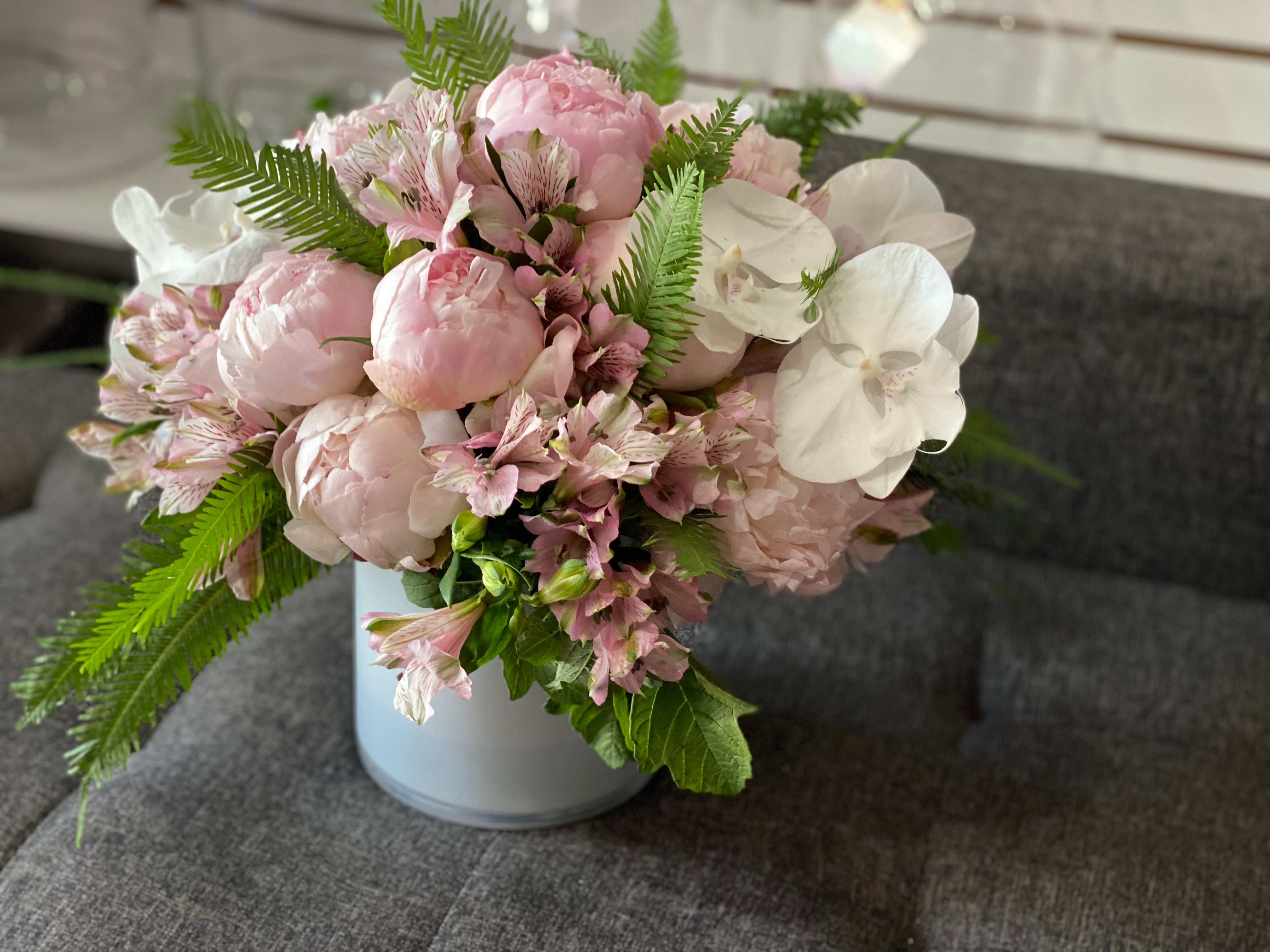 Premium peonies and Phalaenopsis orchids in designer vase