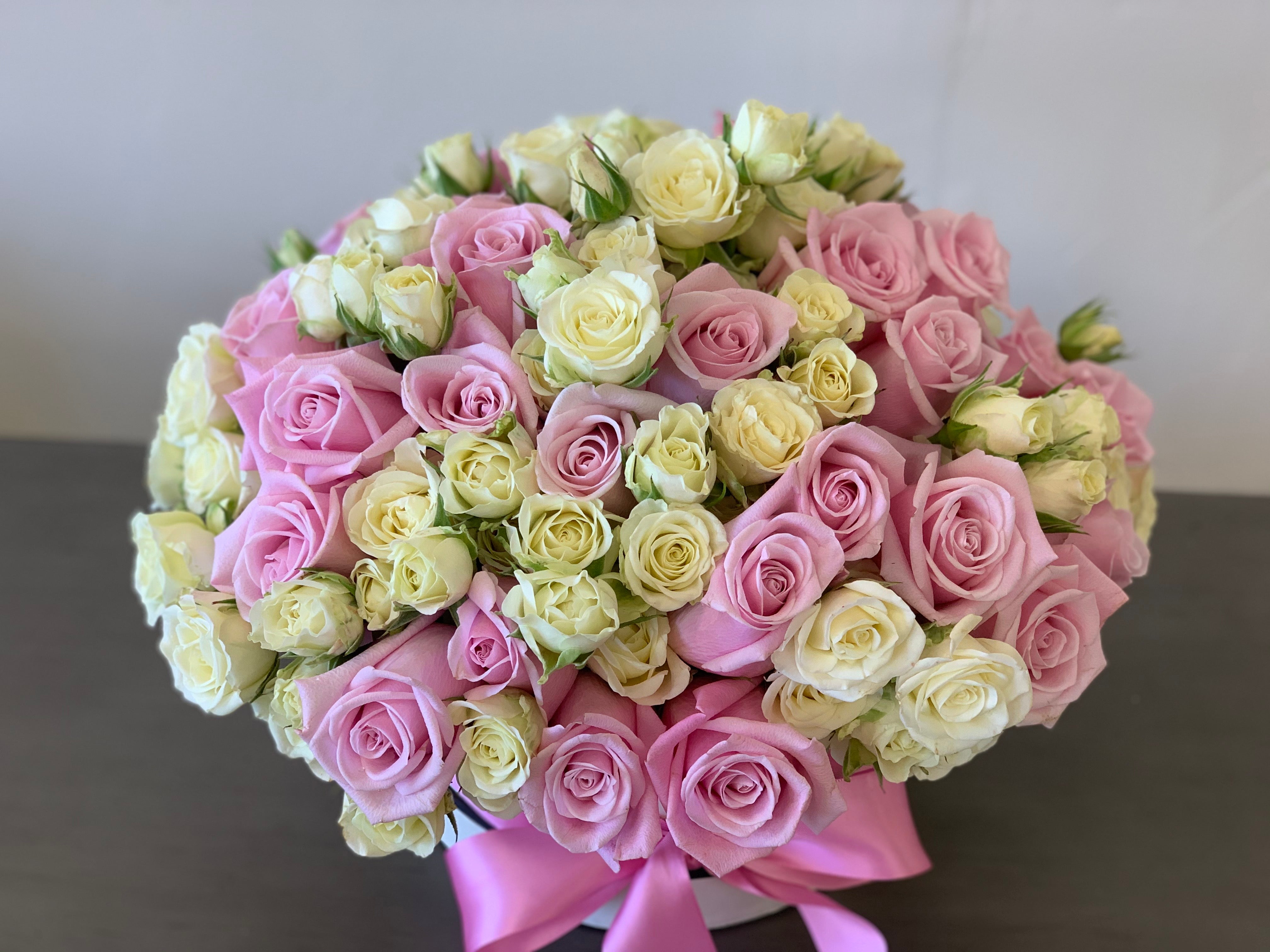 Premium pink roses with delicate white spray roses in a box