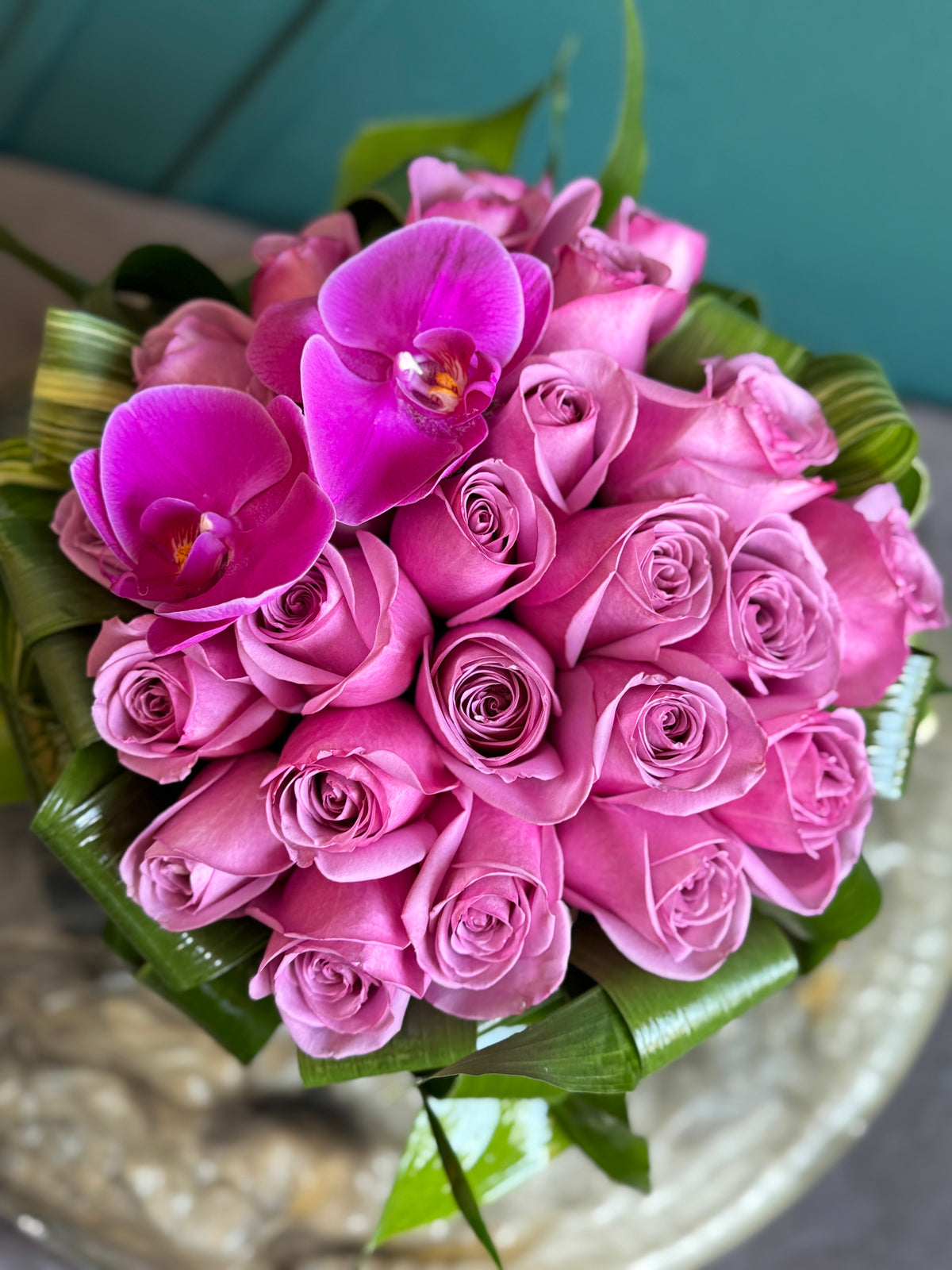 Purple rose arrangement in glass fishbowl vase Miami