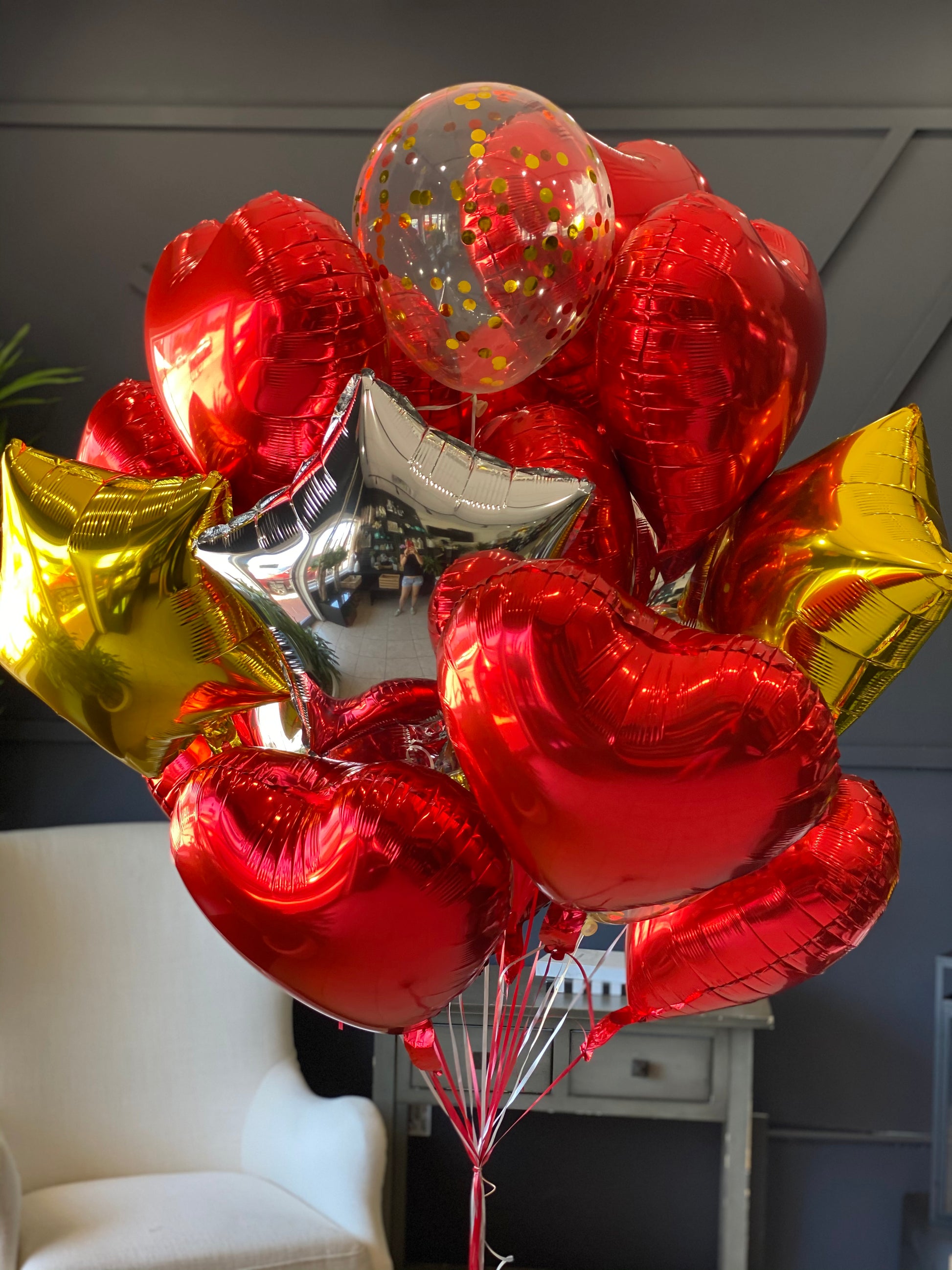 Red and metallic balloon bouquet with clear decorative balloons