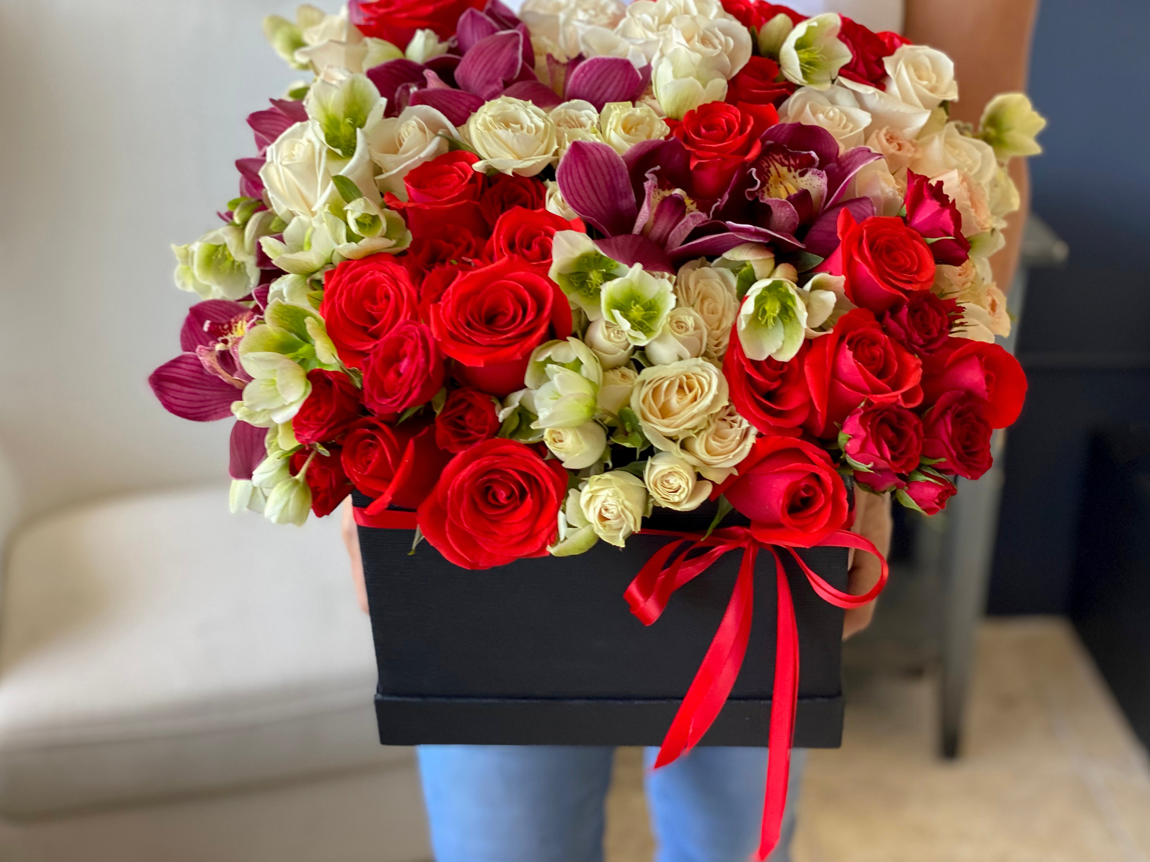 Red and white rose arrangement with cymbidium orchids Miami Beach