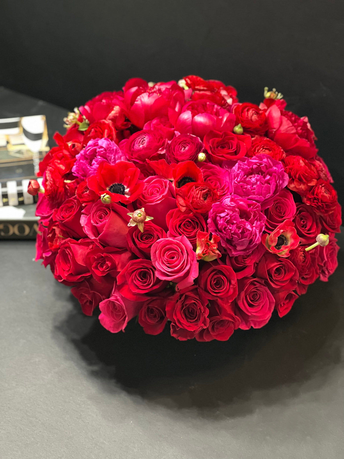 Red roses and hot pink peonies handcrafted flower bouquet
