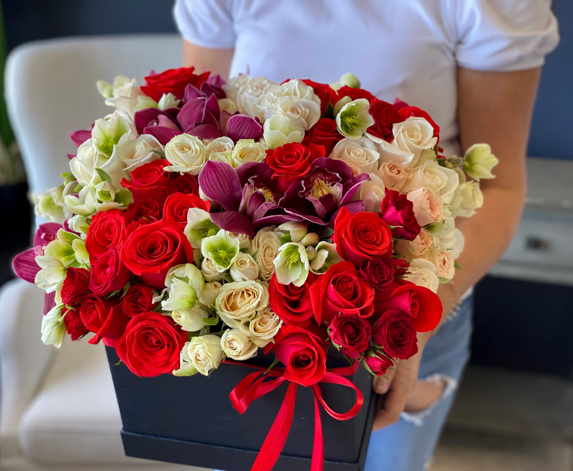 Red roses white roses and red spray roses in luxury black flower box