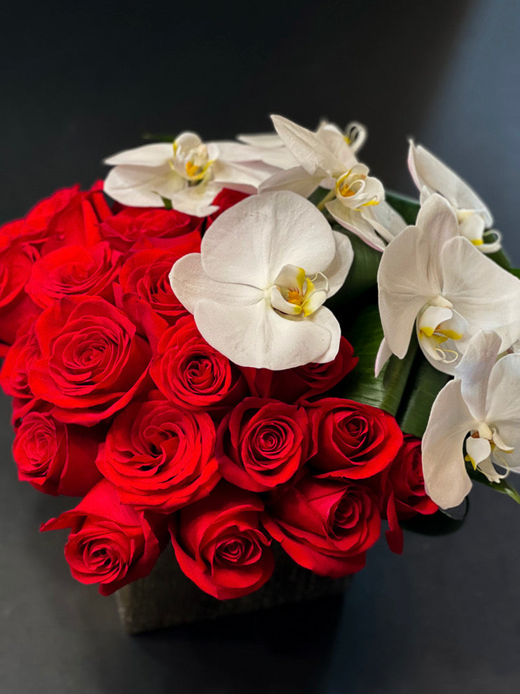 Red roses with white Phalaenopsis orchids for anniversary