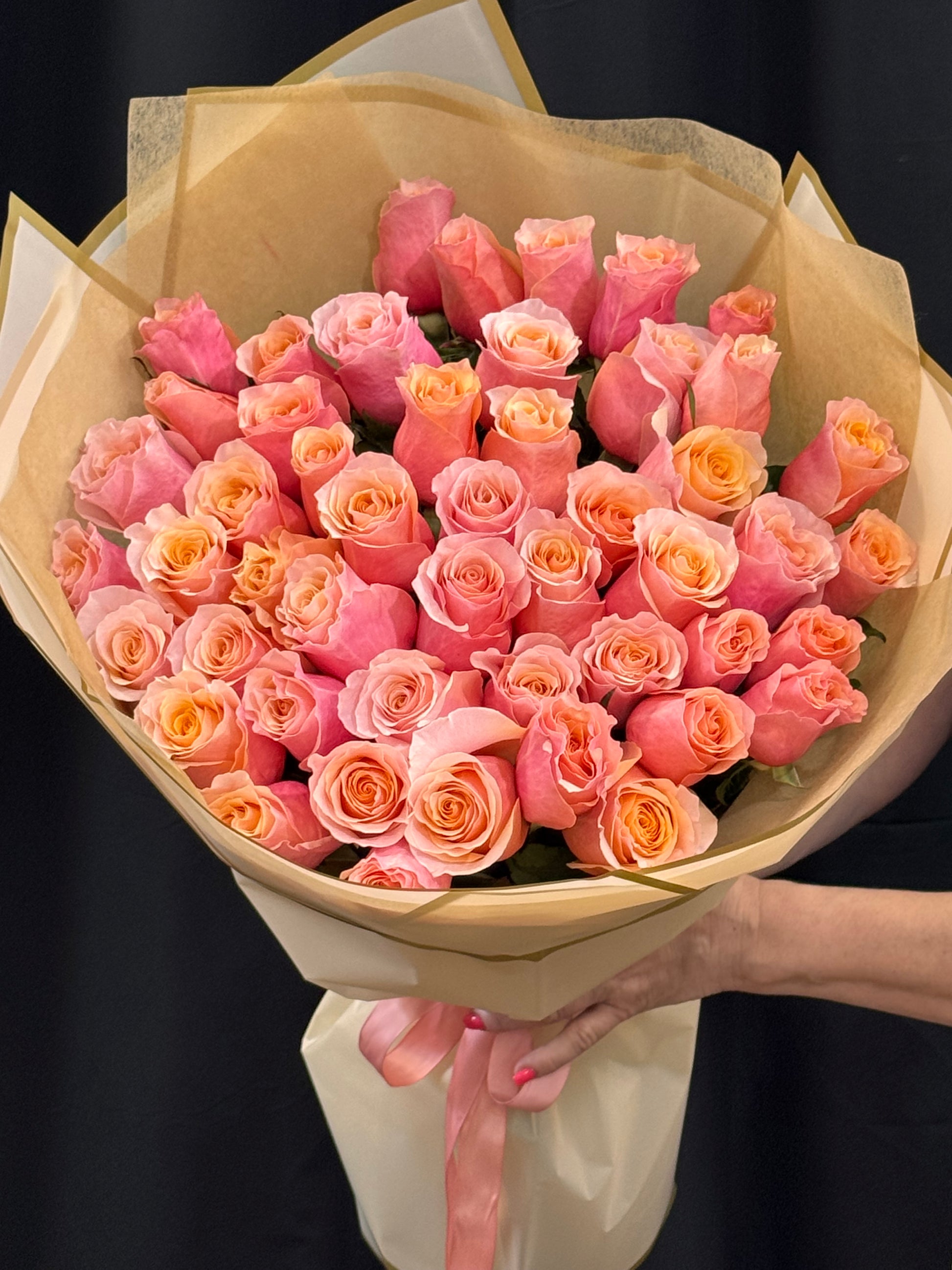 Romantic handcrafted rose bouquet in peach pink and coral tones