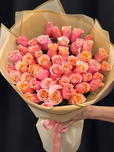 Romantic handcrafted rose bouquet in peach pink and coral tones