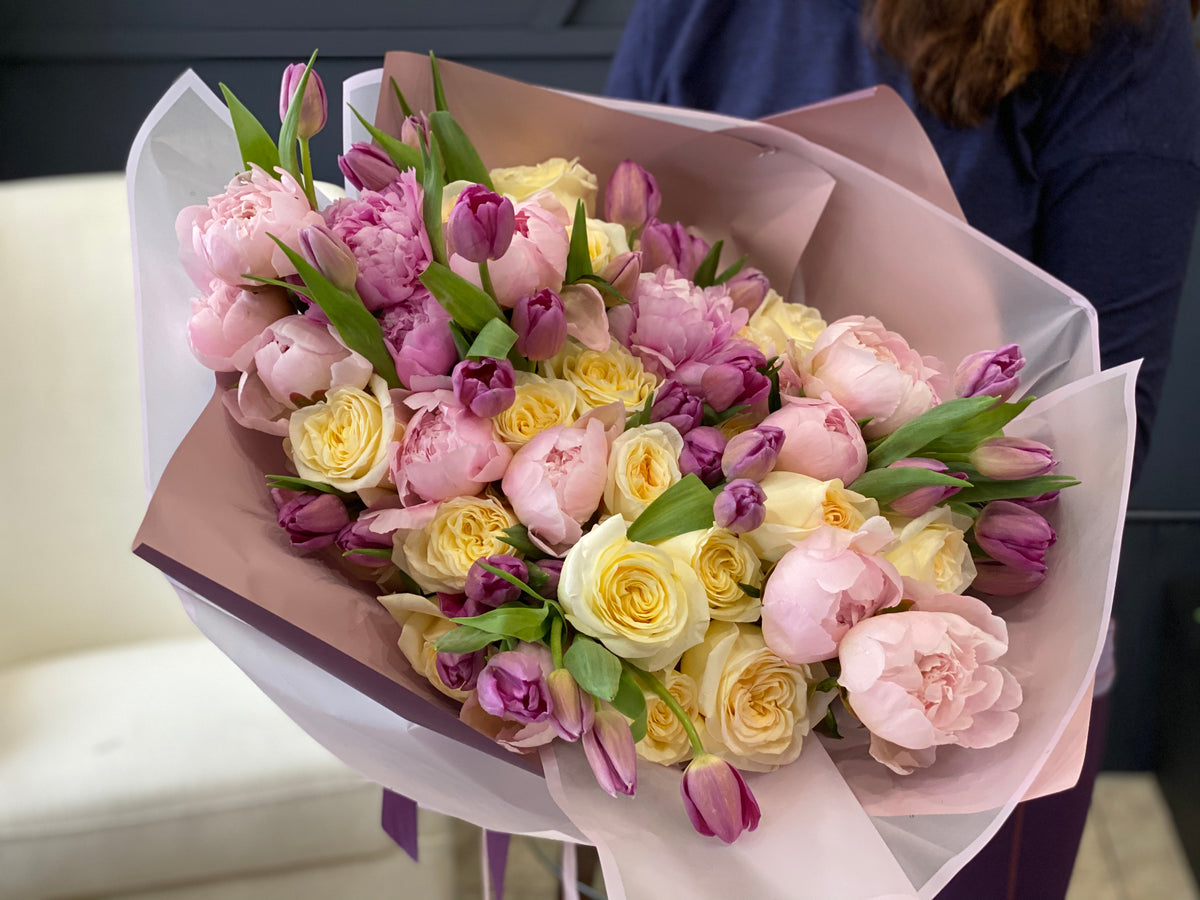 Romantic pastel flower bouquet with pink roses and peonies