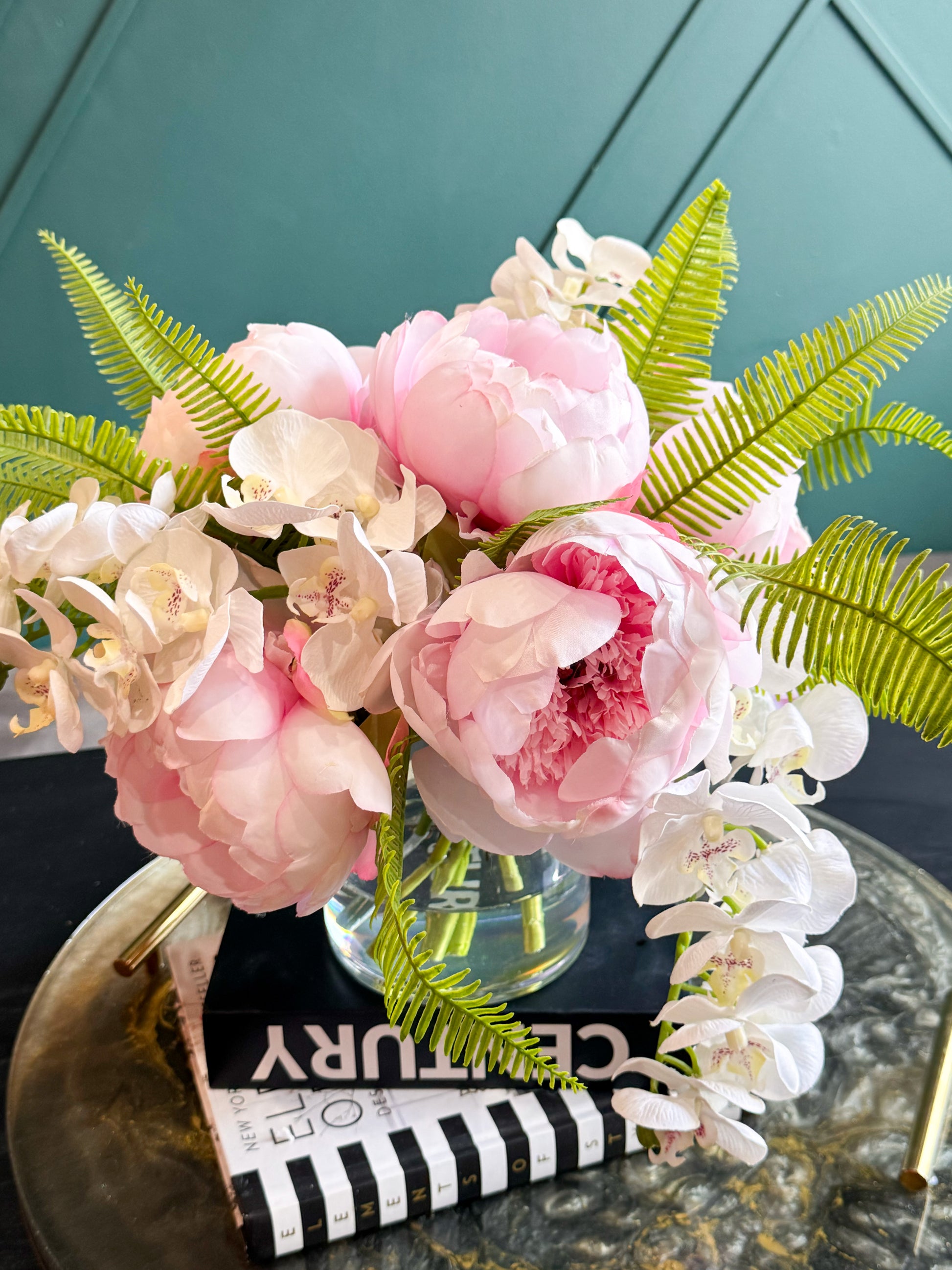 Romantic pink peony and white orchid centerpiece designed for elegant home décor and special occasions.
