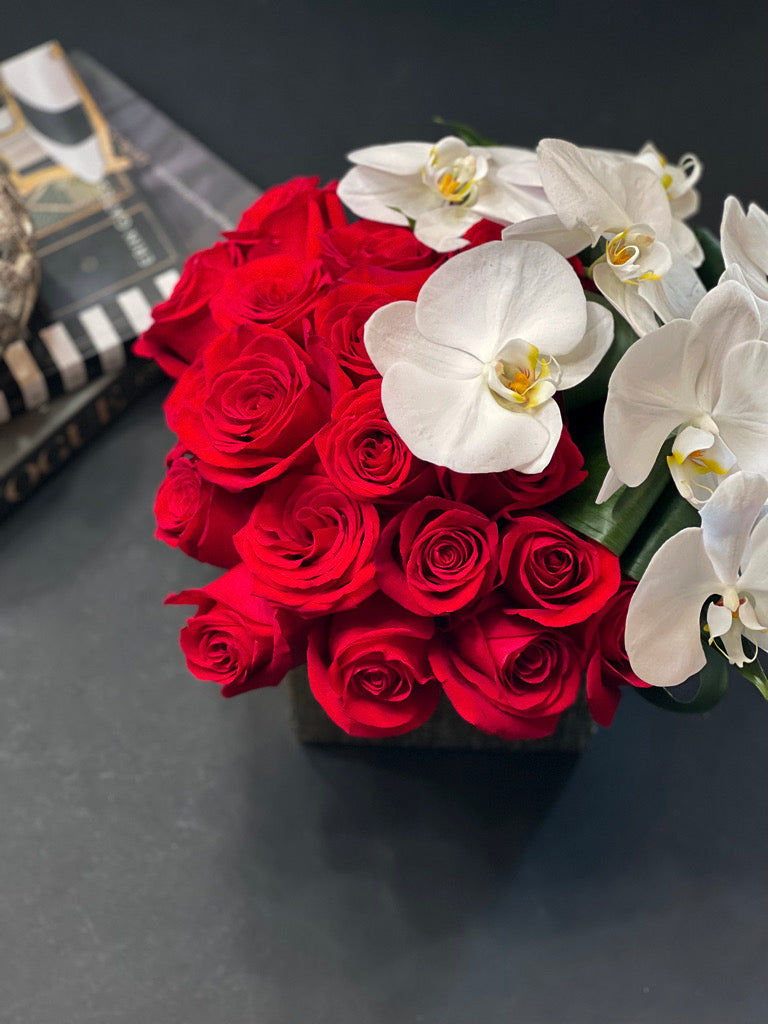 Romantic red roses and white orchid arrangement