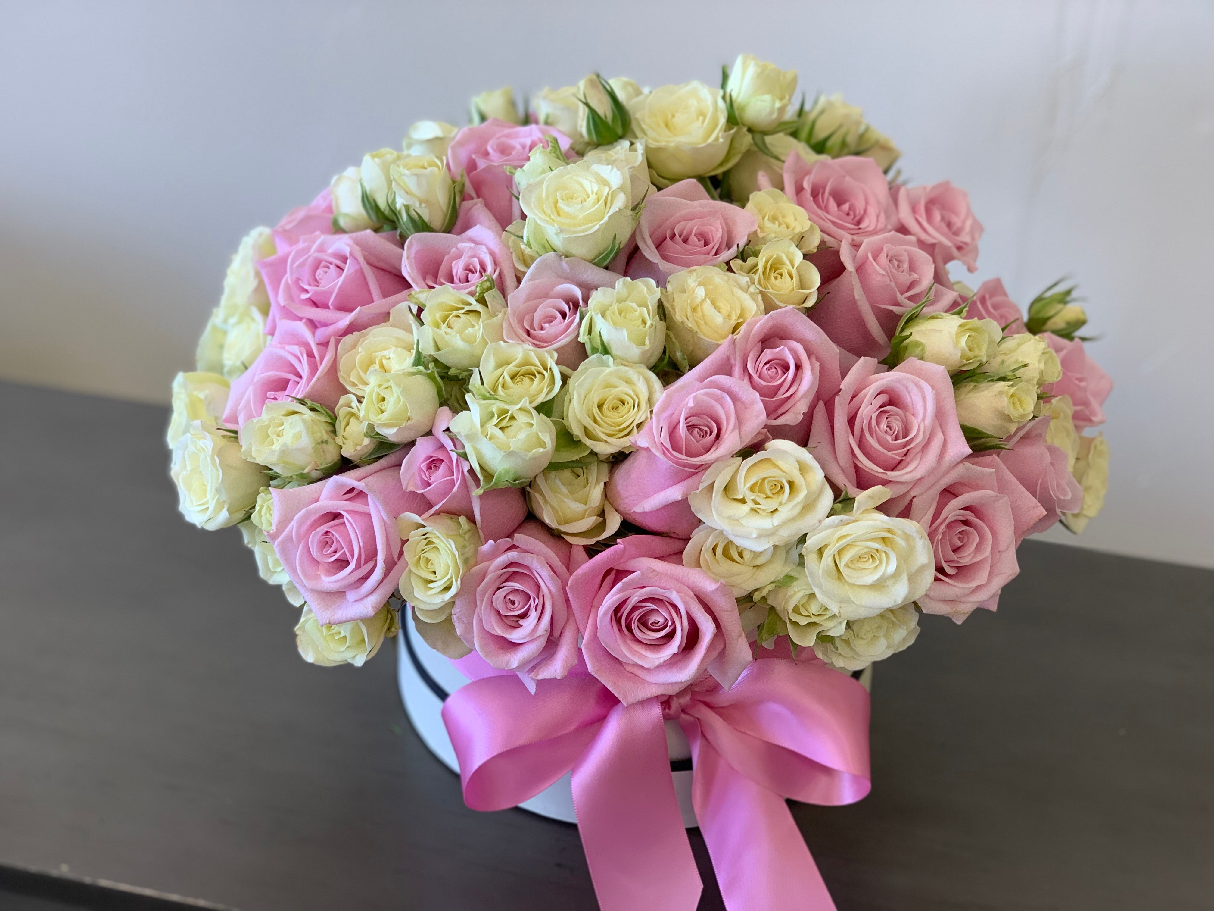 Soft pink roses with petite white spray roses in a luxury box