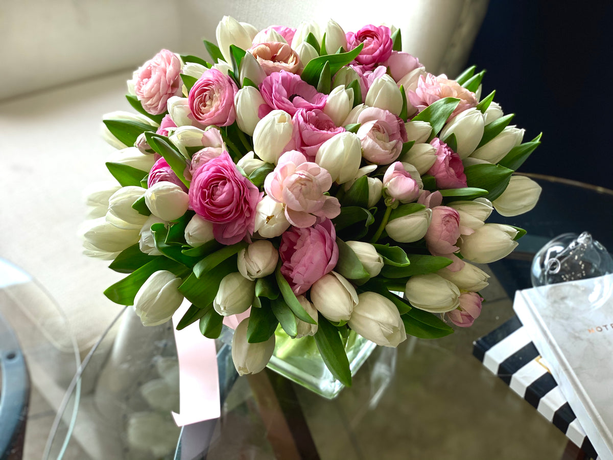 Spring floral arrangement with tulips ranunculus and pink peonies