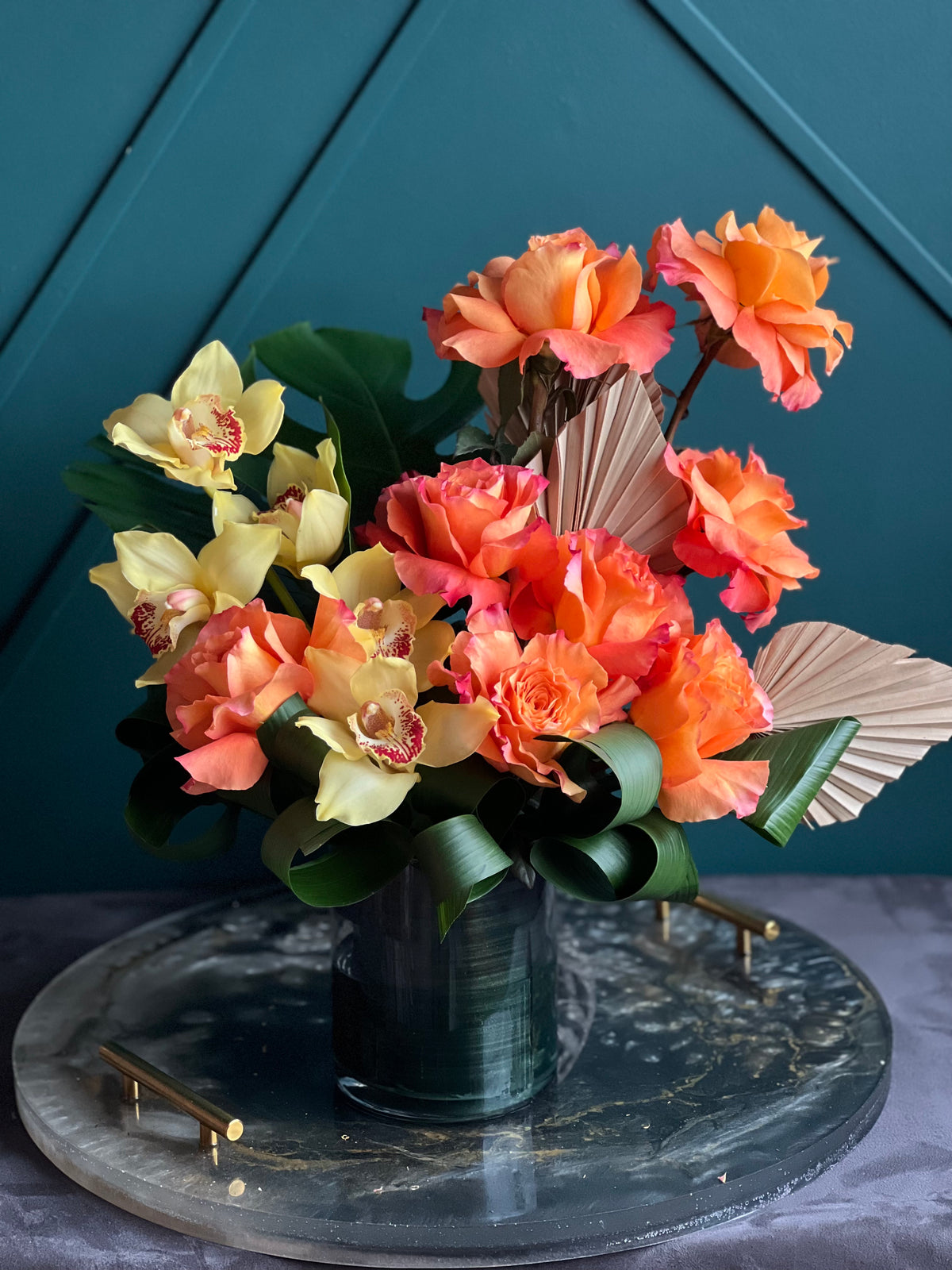 Tropical orange rose and orchid arrangement by Luxury Flowers Miami