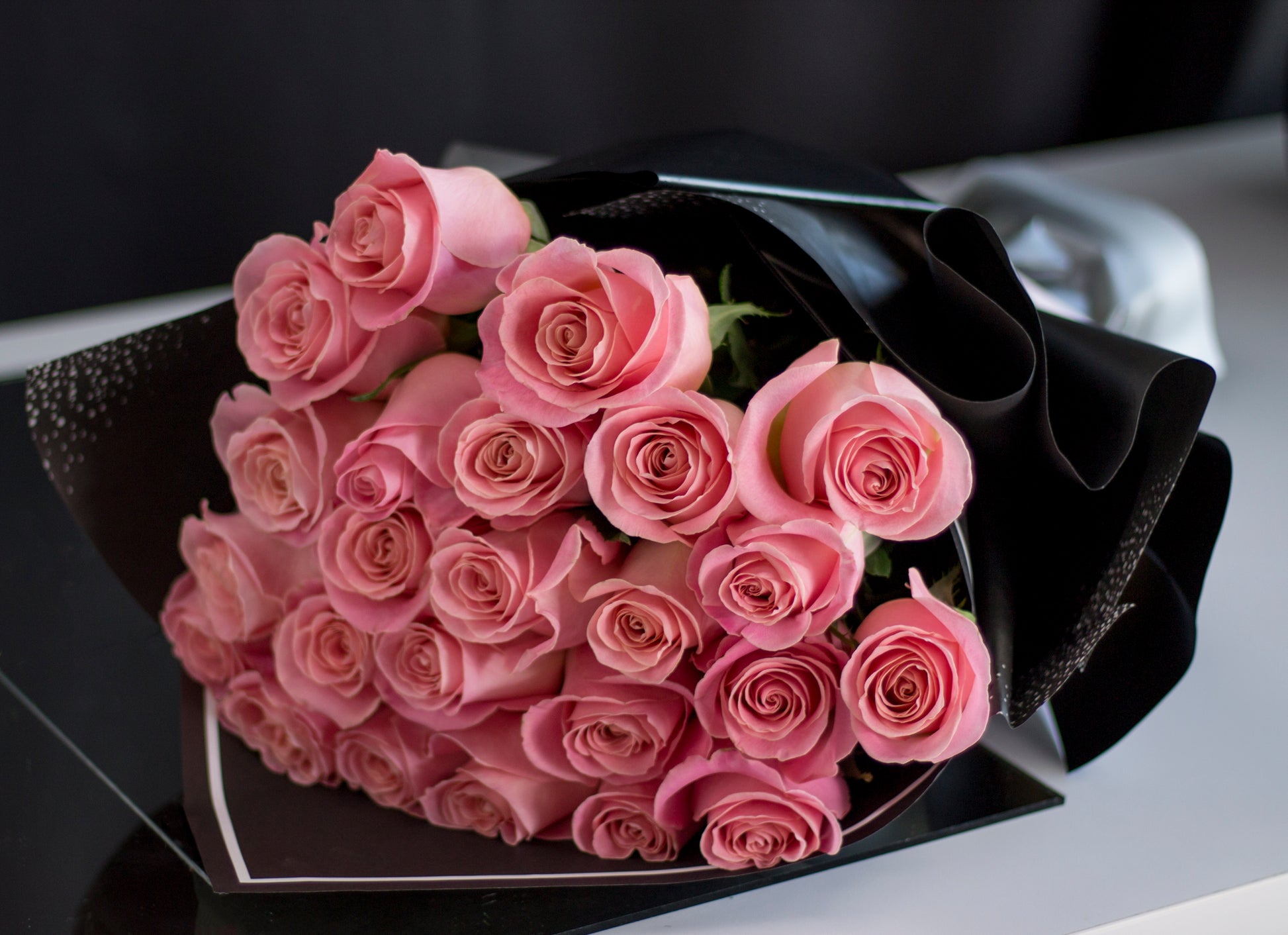Twenty-four blush pink roses hand-crafted by Miami florists