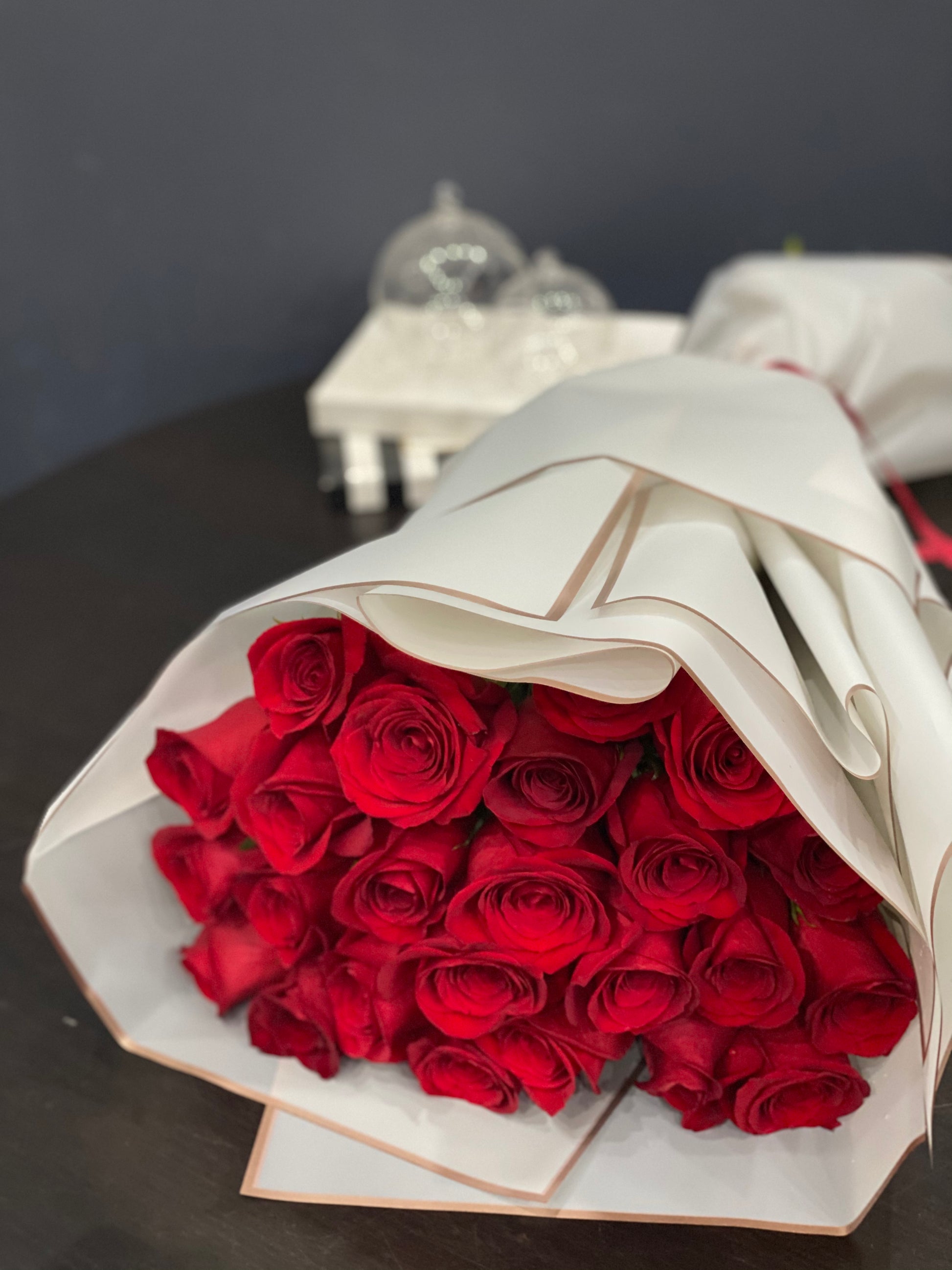 Two dozen premium red roses in elegant wrapped bouquet