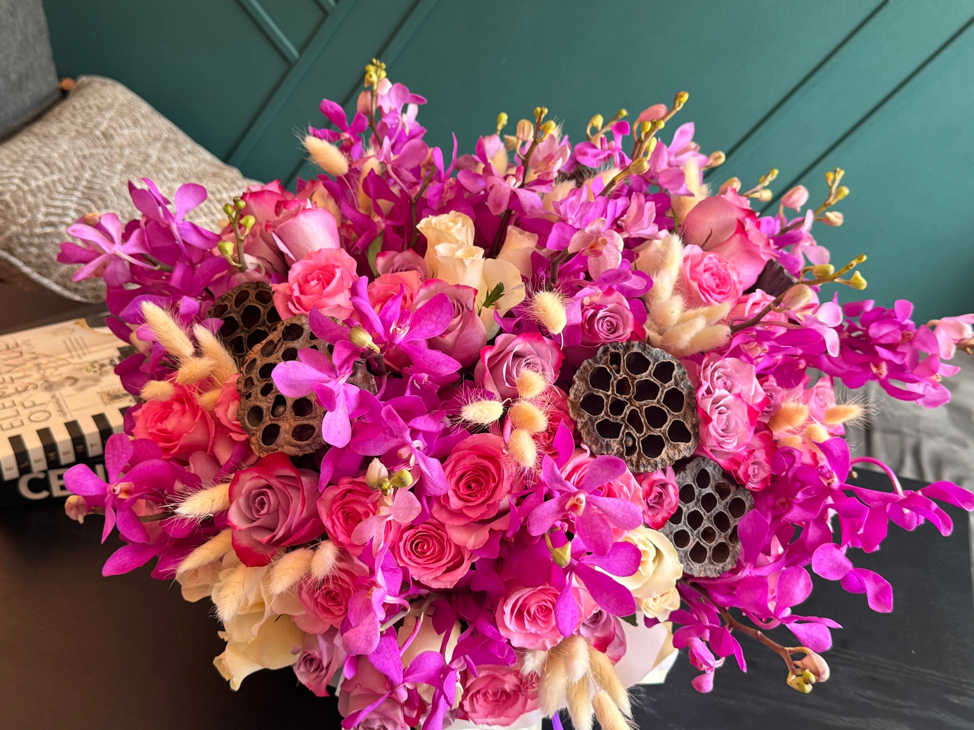 Vibrant pink Mokara orchids and premium roses in flower box