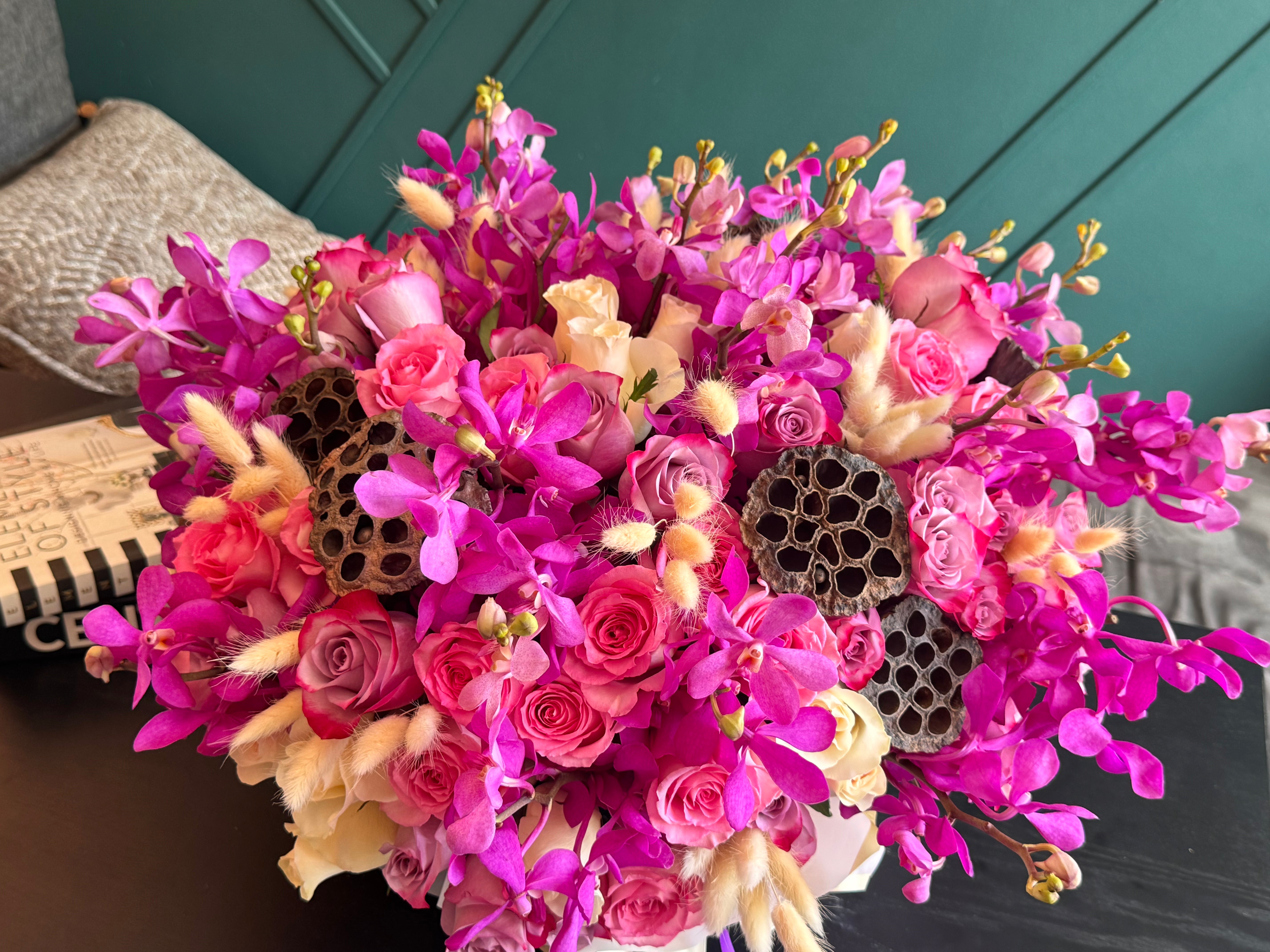 Vibrant pink Mokara orchids and premium roses in flower box