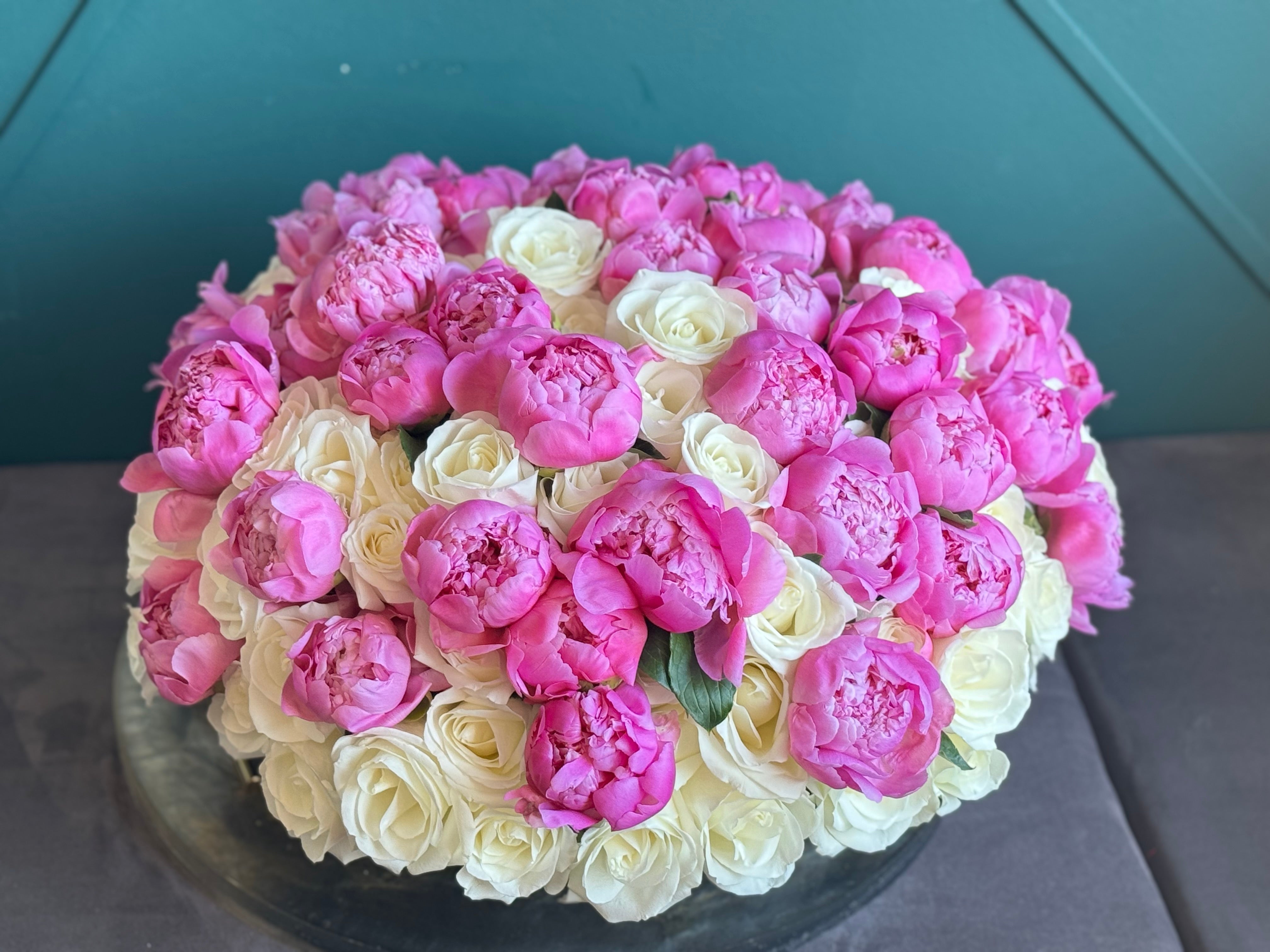 White roses and peonies centerpiece in a cement vase for Miami delivery
