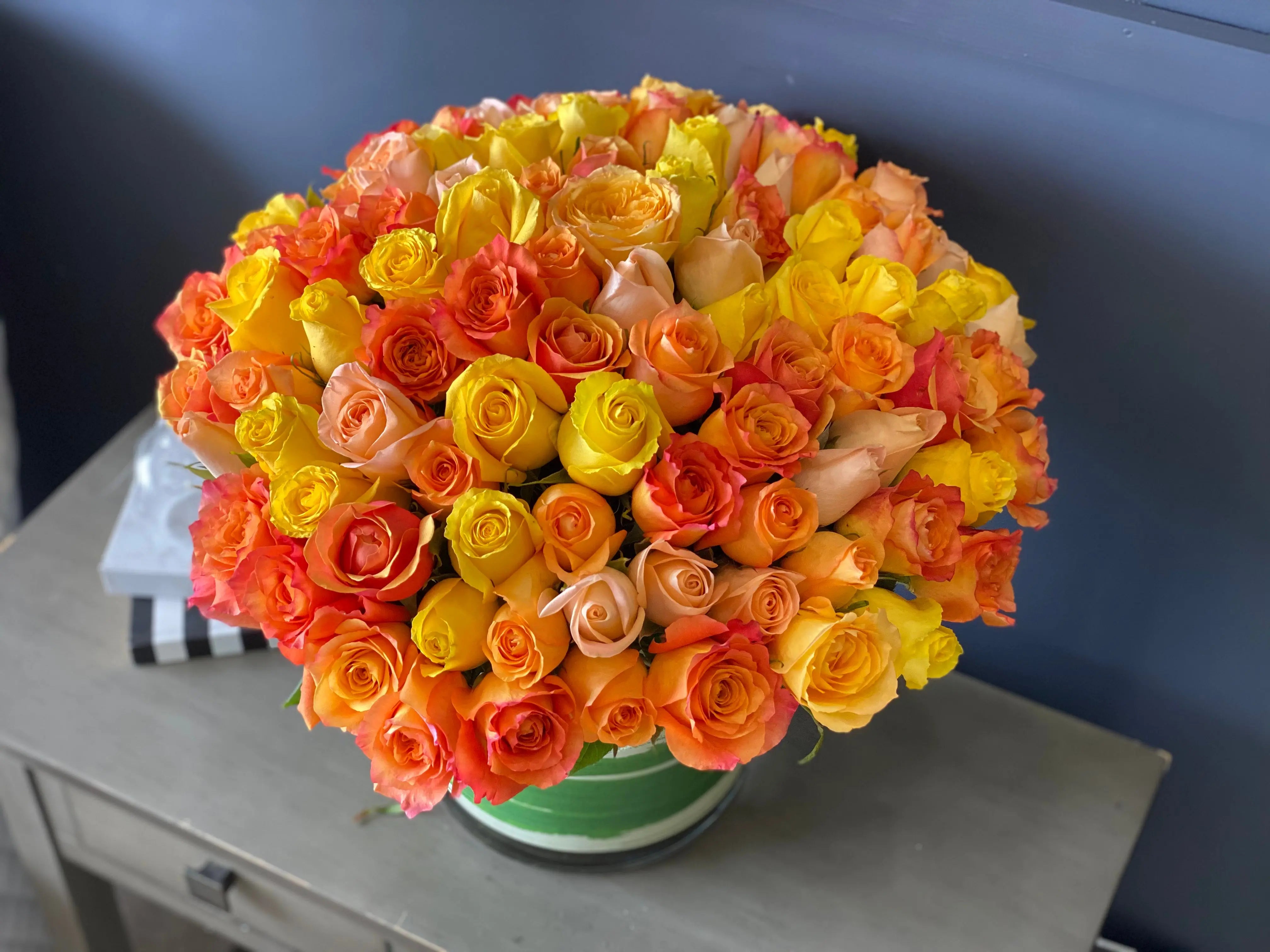 Yellow orange and peach rose arrangement for birthday in Miami