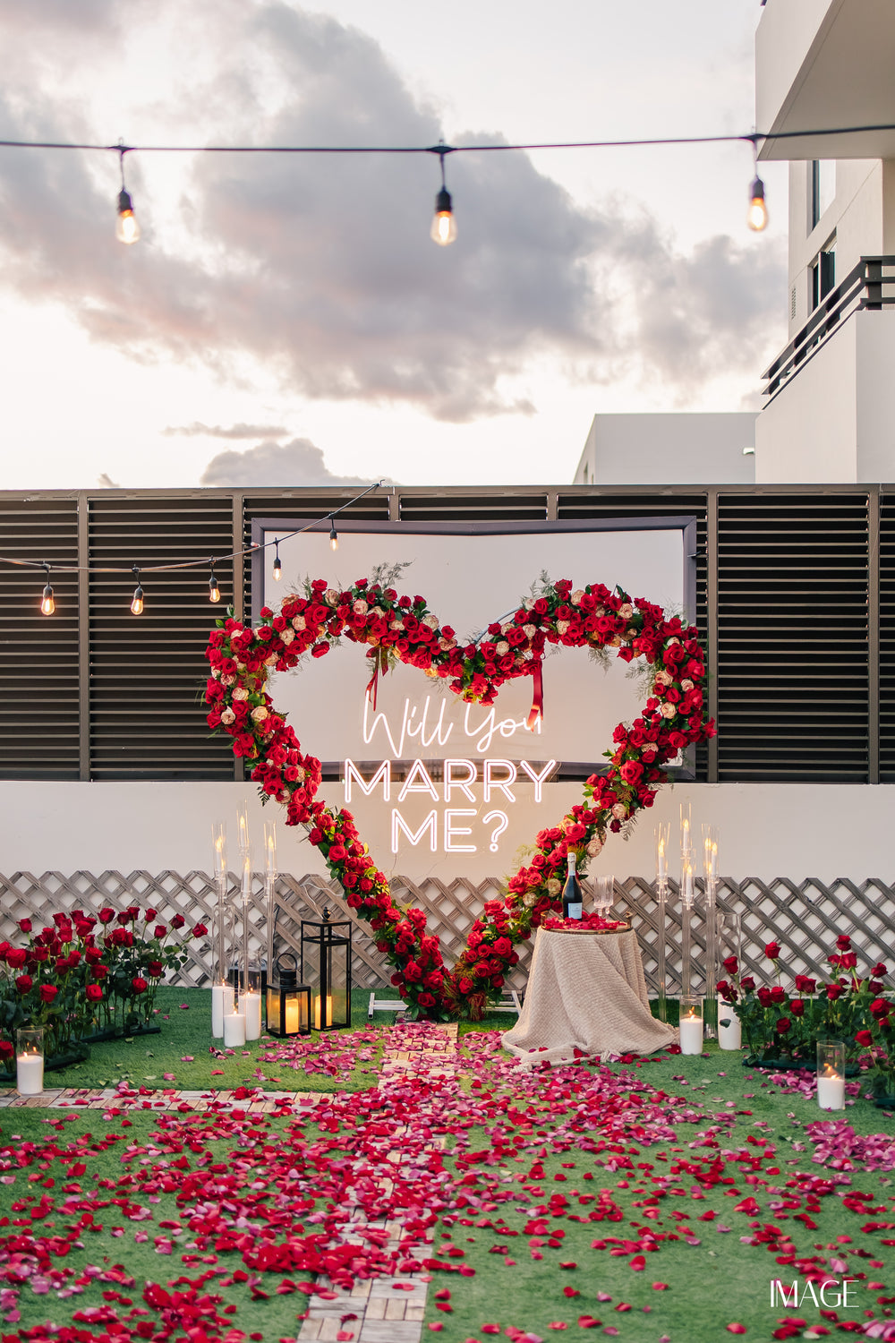 Luxury rooftop proposal in Miami with flowers, candles and MARRY ME letters