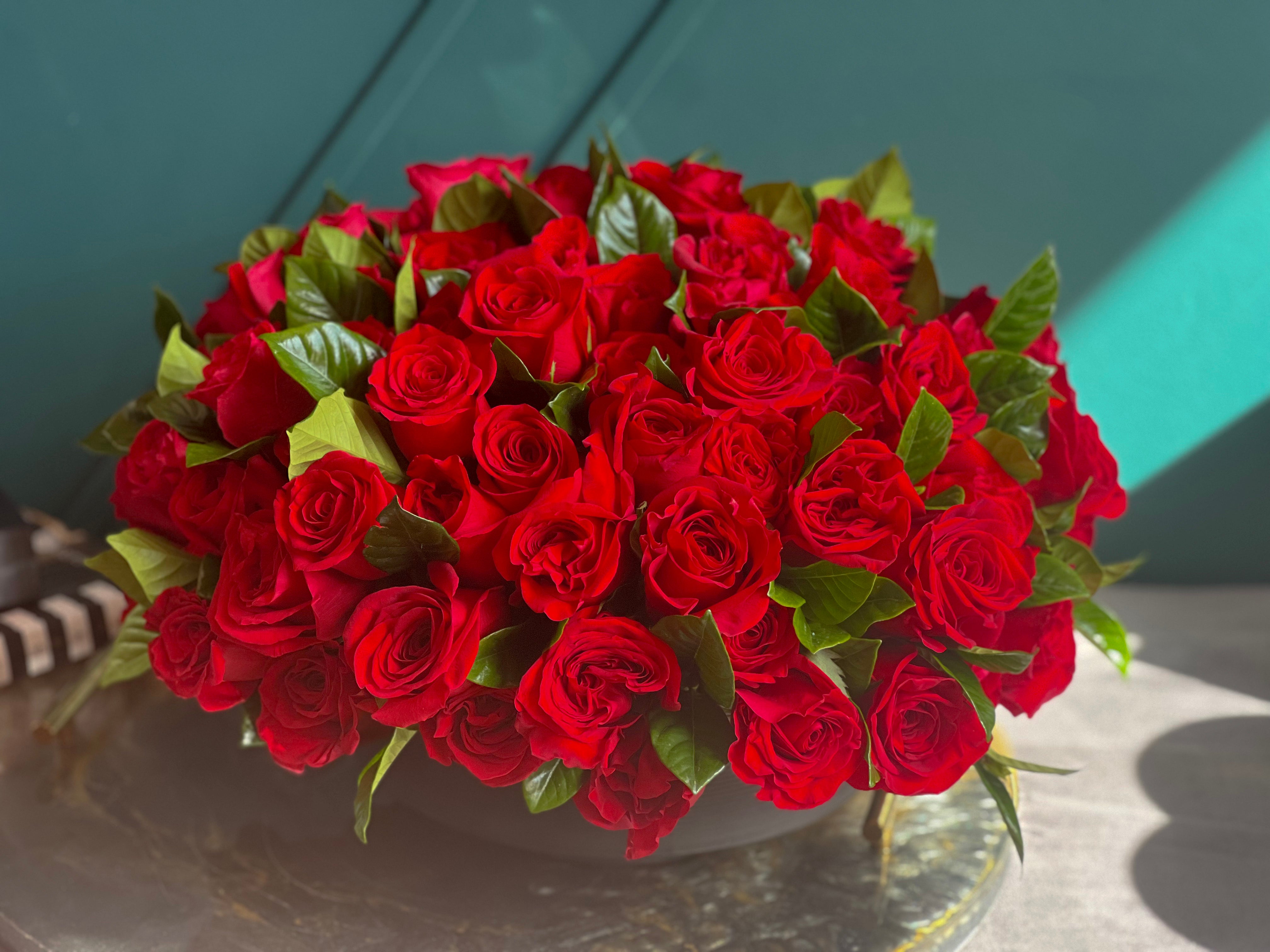 large red rose arrangement in low vase Miami