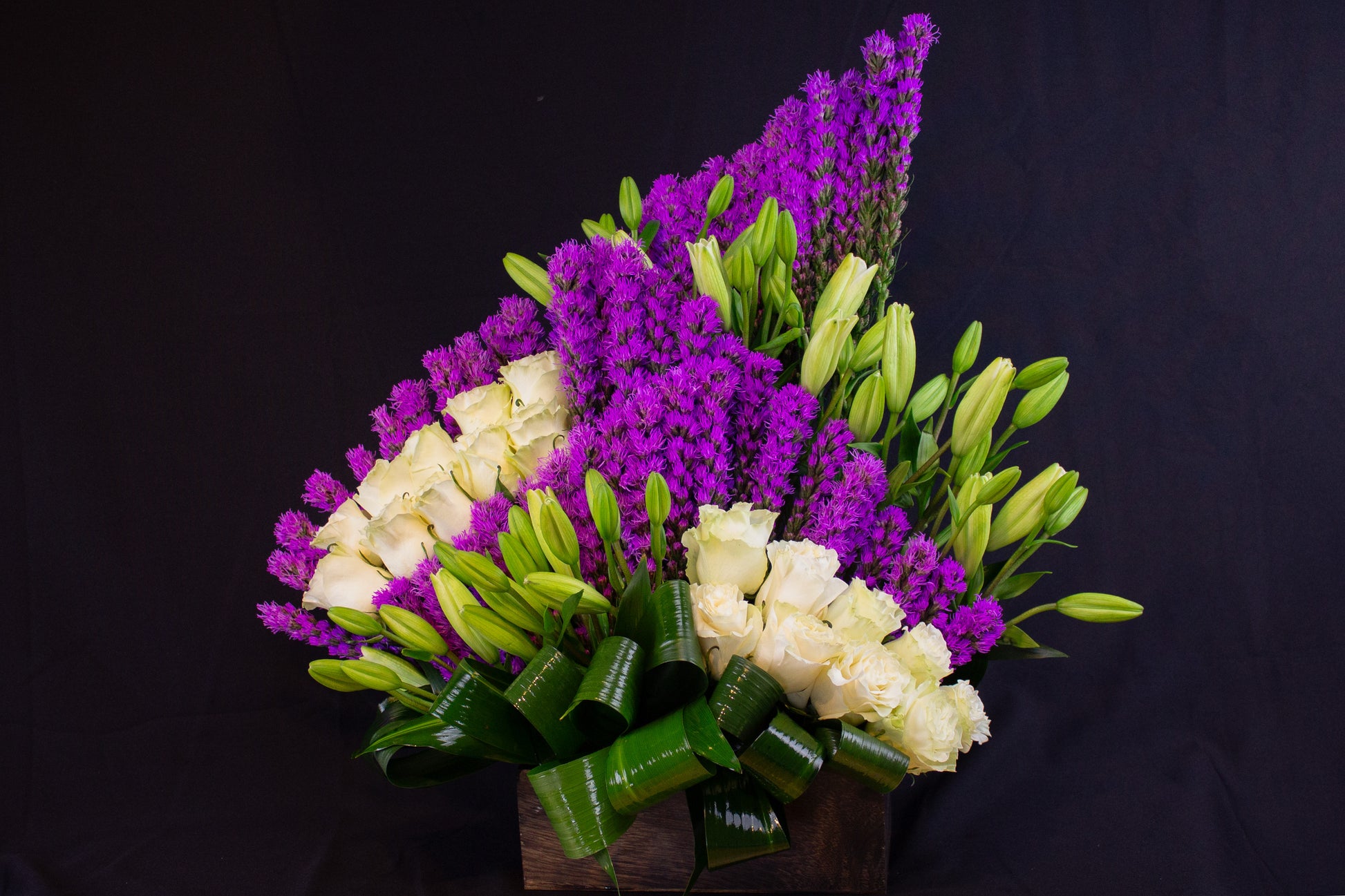luxury white roses lilies and purple liatris arrangement