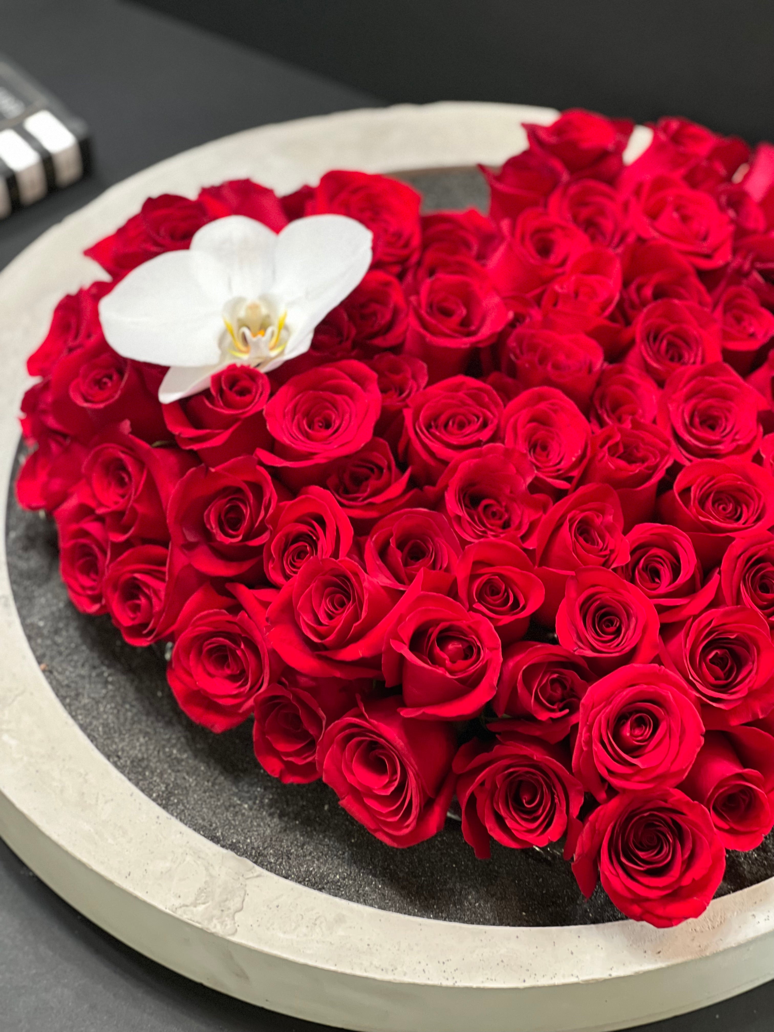modern red rose arrangement with black sand Miami Beach