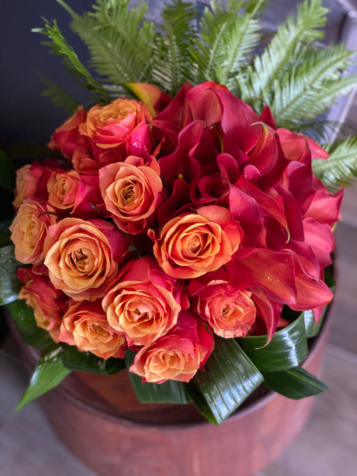 orange roses and calla lilies arrangement miami