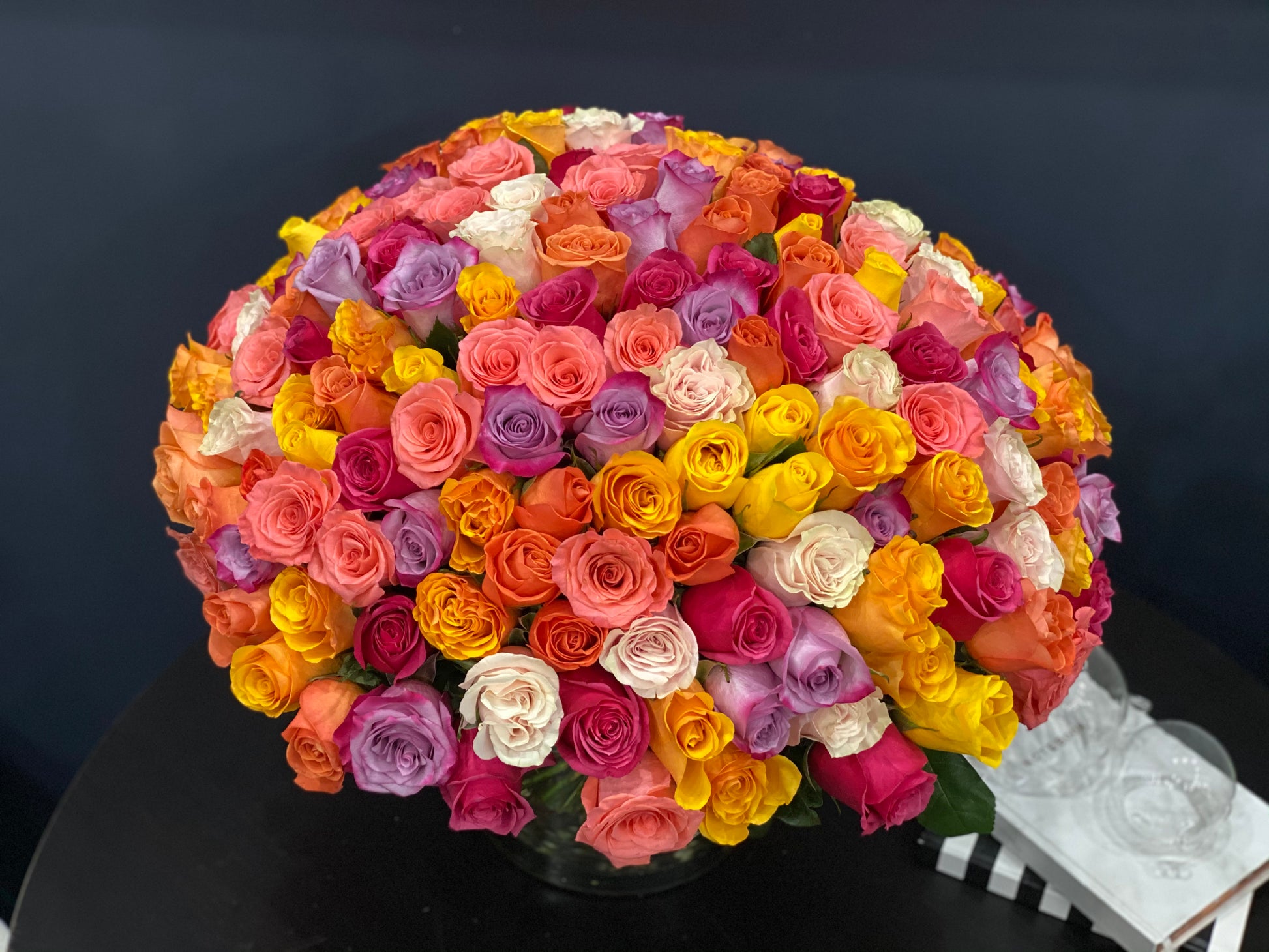 pink peach orange yellow and lavender roses in vase