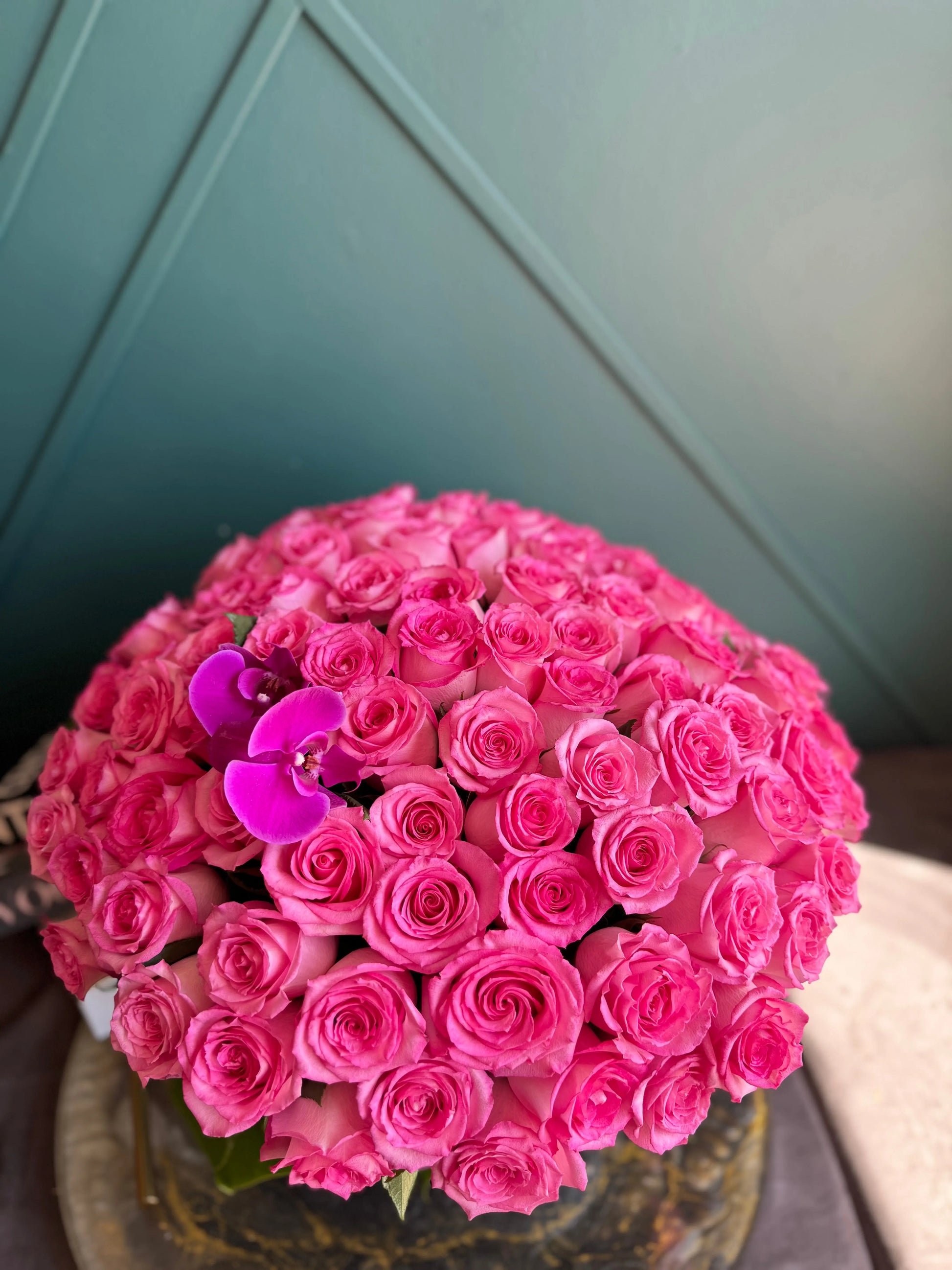 pink roses in clear fishbowl vase Miami florist