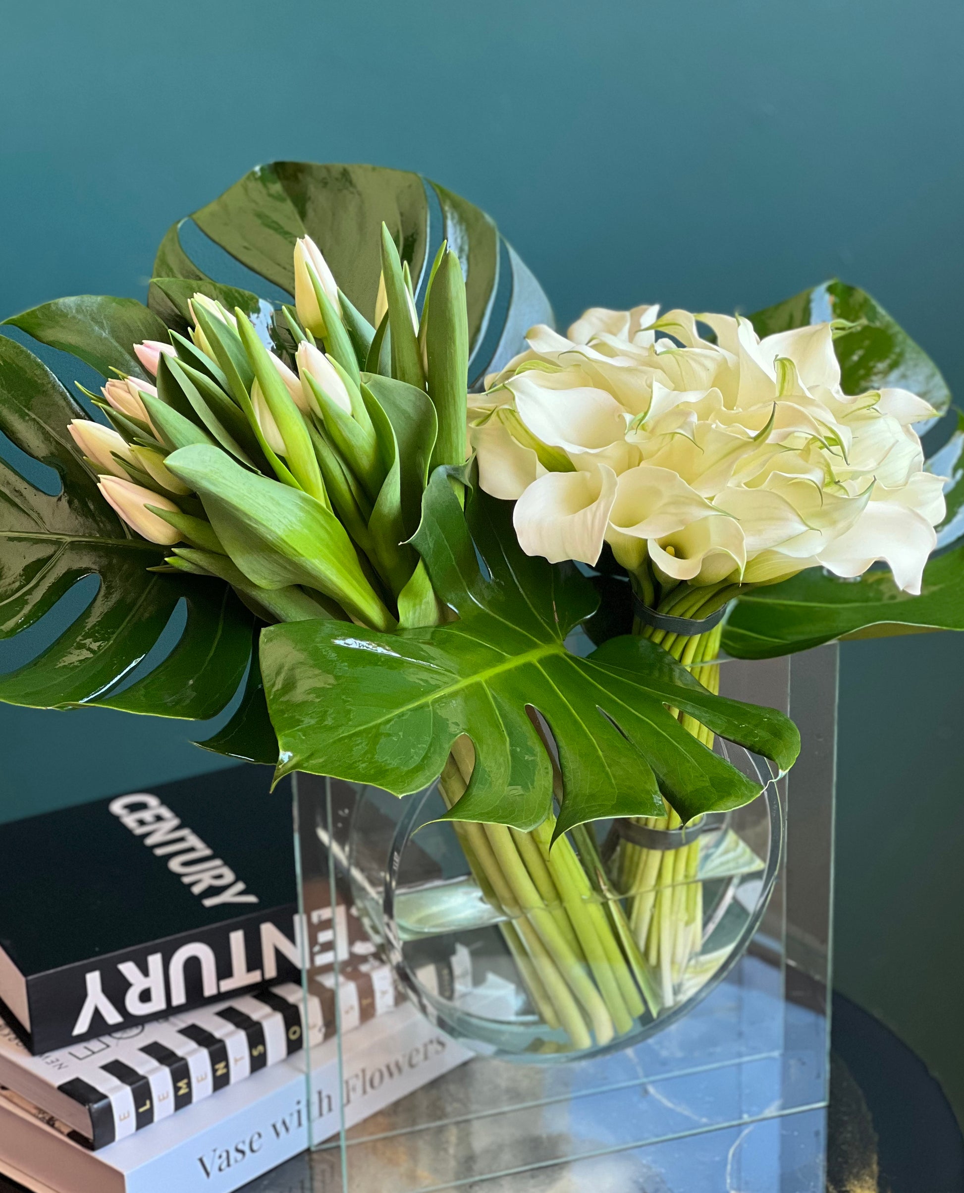 white calla lilies and tulips with tropical greenery Miami